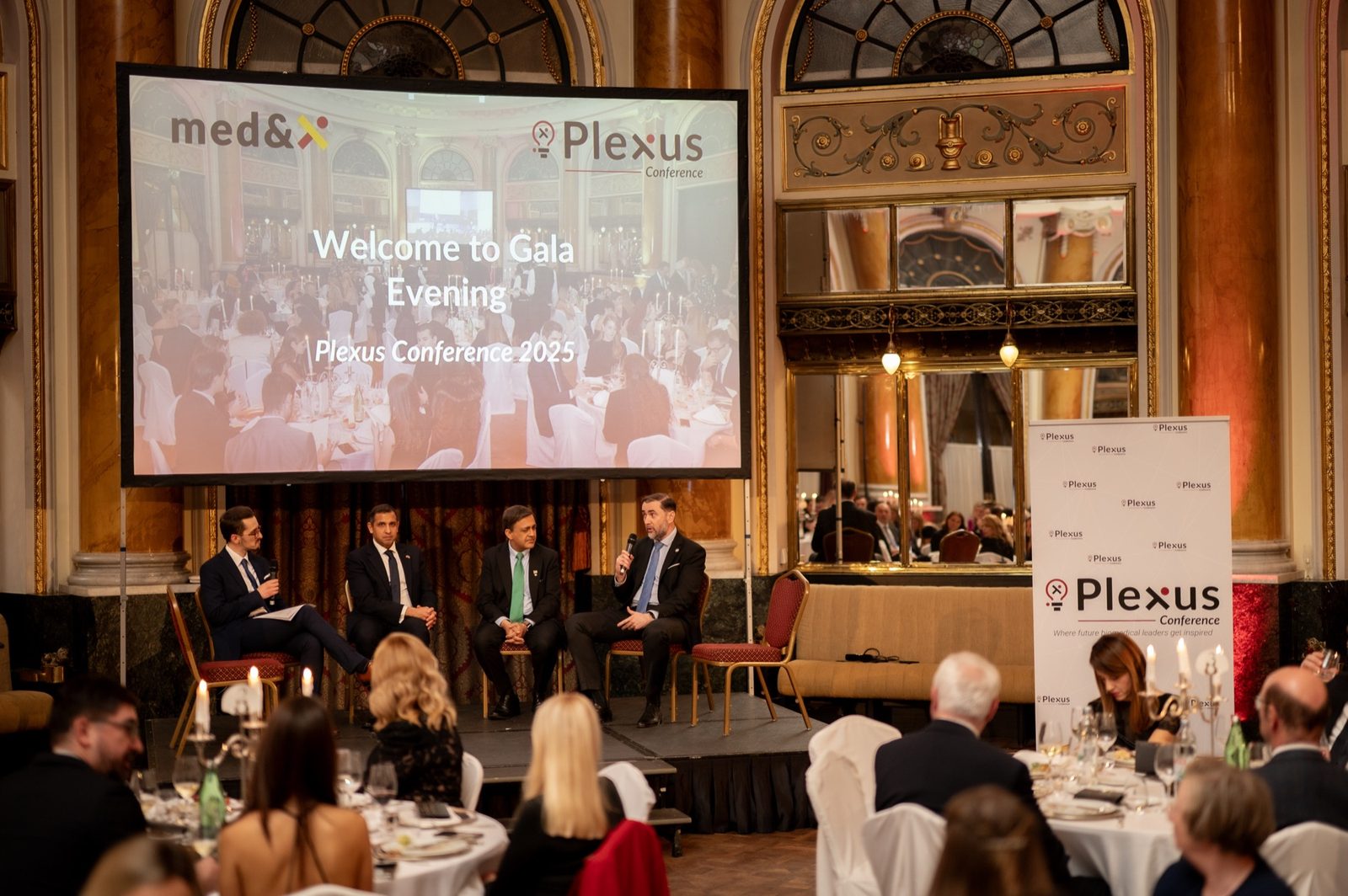 Speakers on stage during a panel discussion at the Plexus conference