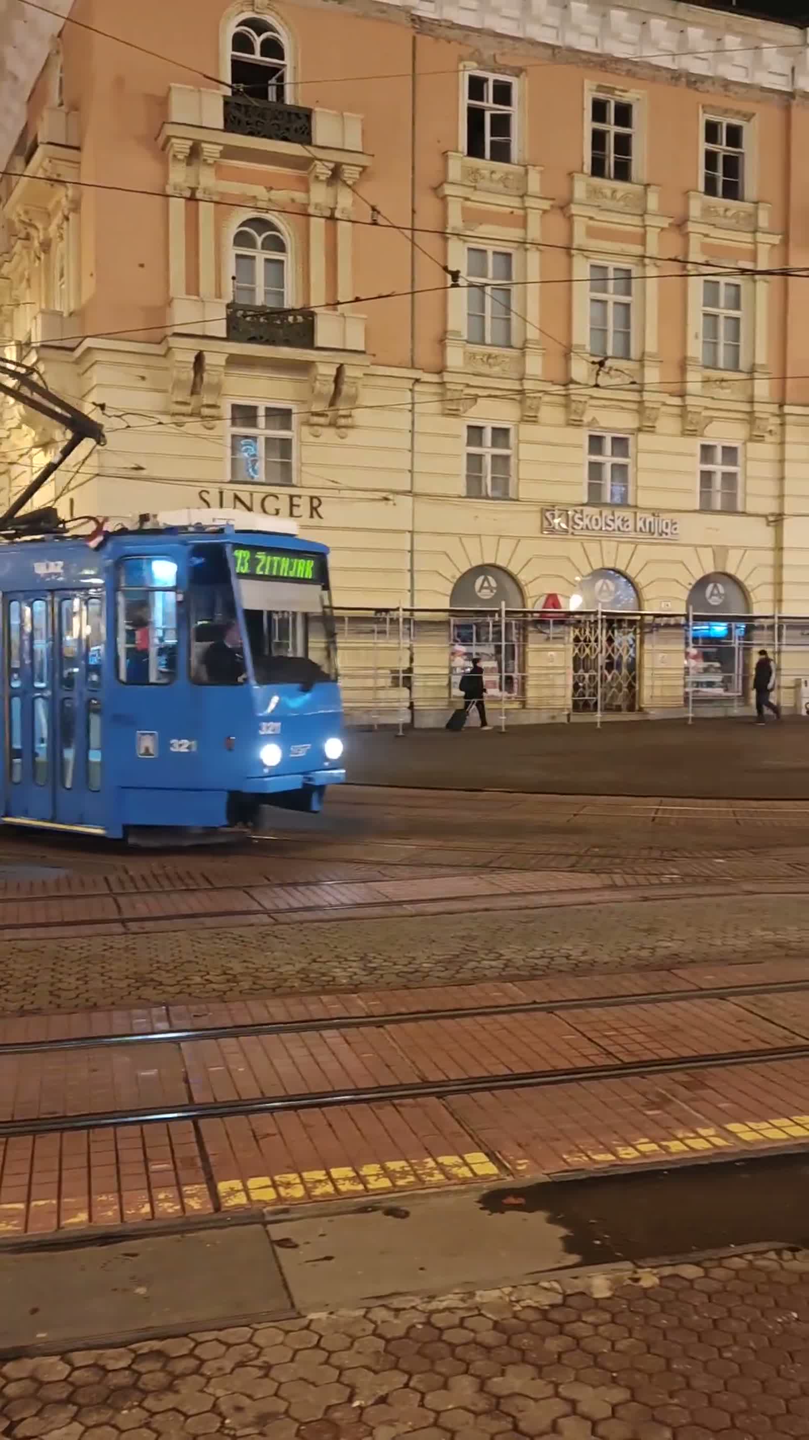 A blue tram on a Zagreb square