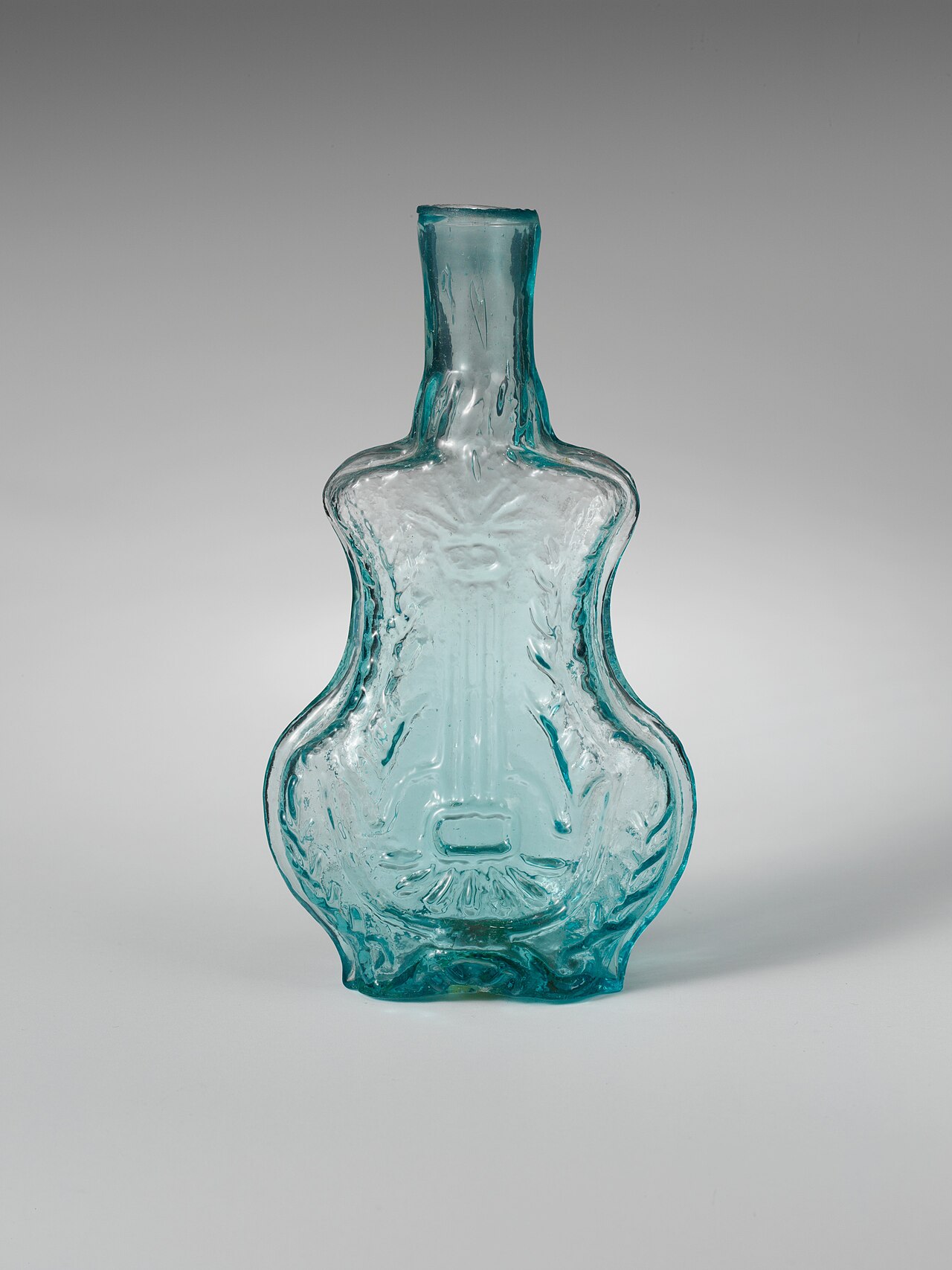 A cut-glass perfume bottle